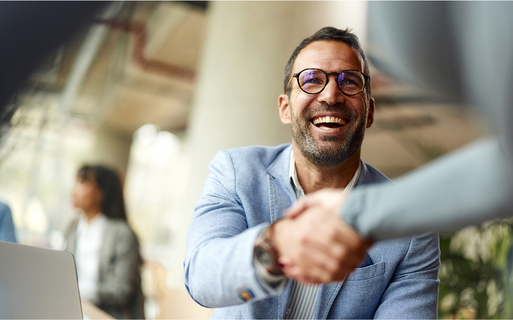 Two people reviewing insurance information on a laptop